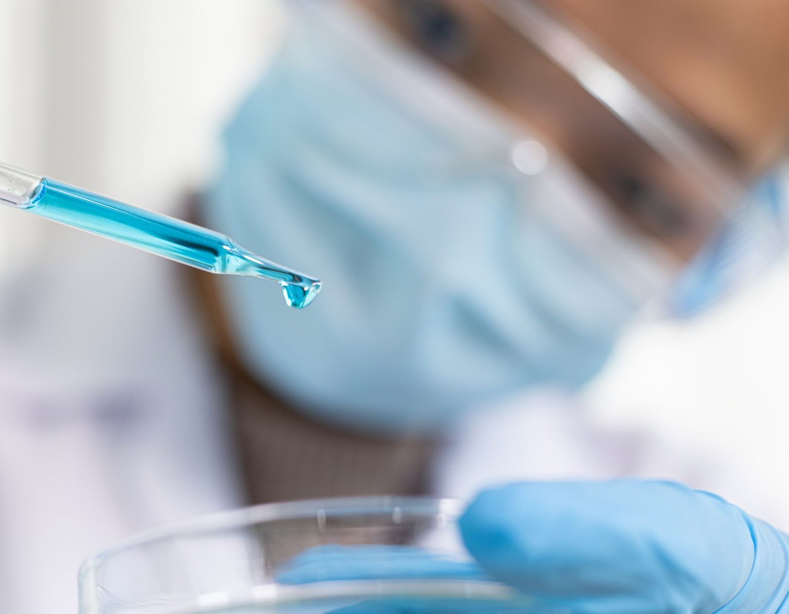 Person using a pipette in a pharmaceutical setting