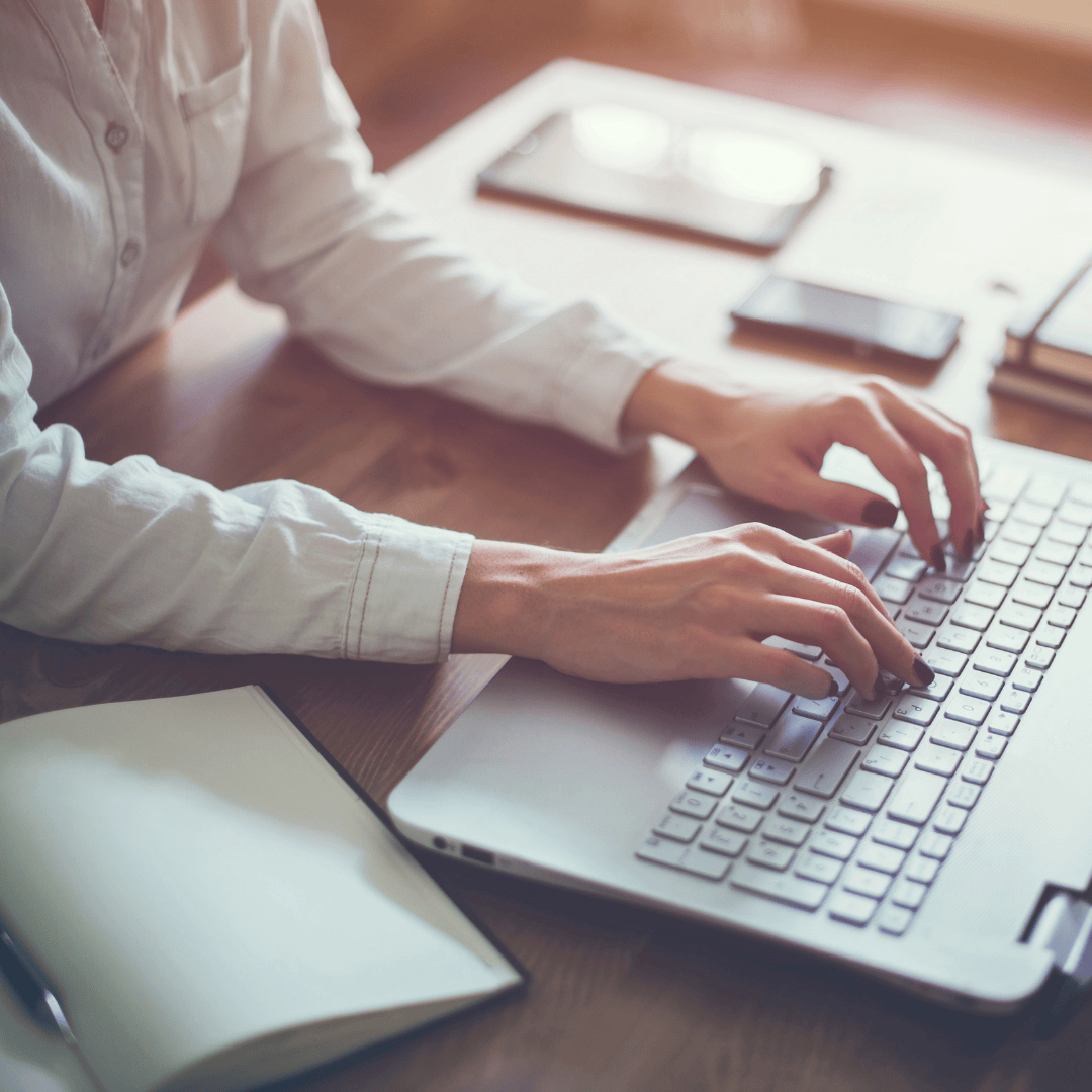 copywriters typing on a laptop