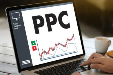 person typing on laptop where the screen displays a graph with the words 'PPC'